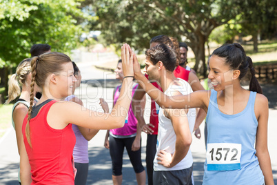Fit women high fiving before race