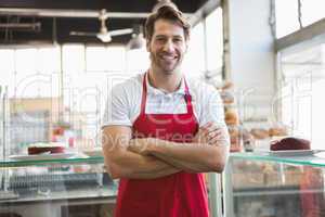 Portrait of happy server with arms crossed