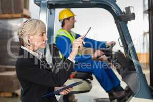 Warehouse manager checking her inventory