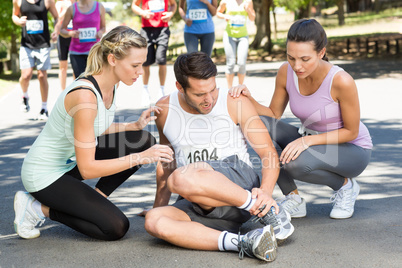 Man with injured ankle during race in park