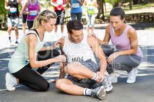 Man with injured ankle during race in park