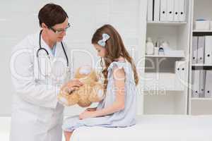 Doctor examining little girl