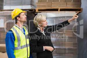 Warehouse manager pointing something to his colleagues