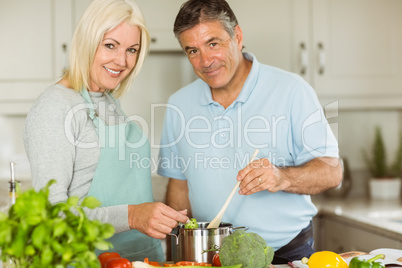 Happy mature couple making dinner together