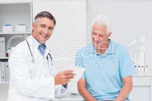 Doctor explaining prescription to senior man