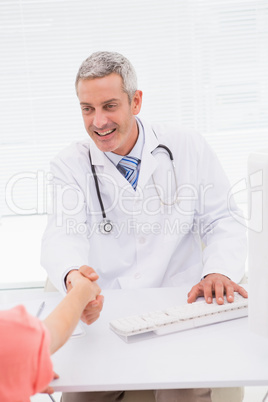 Happy doctor handshake at his patient