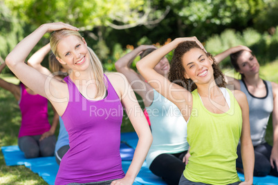 Fitness group doing yoga in park