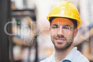 Close up of worker wearing hard hat in warehouse