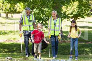 Happy family collecting rubbish