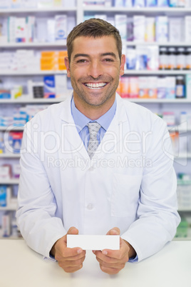 Handsome pharmacist holding medicine box