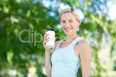 Pretty blonde holding bottle of water
