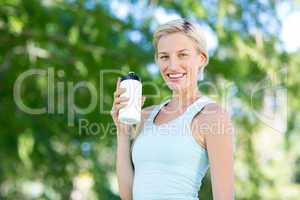 Pretty blonde holding bottle of water