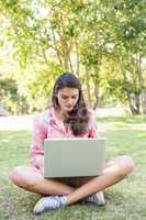 Woman using laptop in park