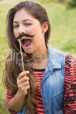 Pretty brunette with fake mustache