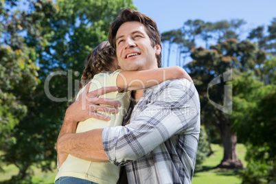 Father and daughter hugging in the park