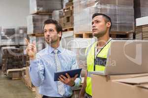 Warehouse worker and manager working together