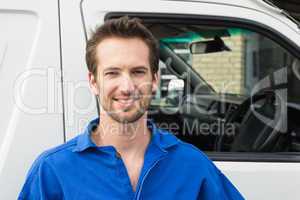 Smiling man in front of delivery van