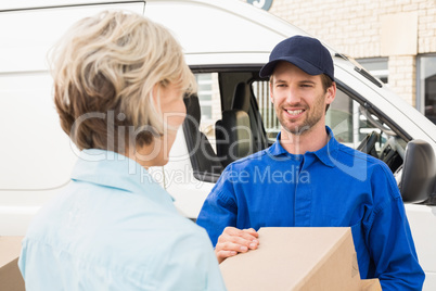 Delivery driver passing parcels to happy customer