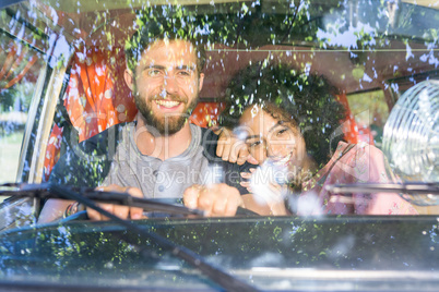 Hipster couple driving in camper van