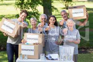 Happy volunteer family with thumbs up