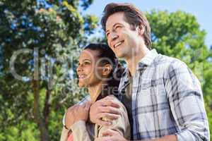 Happy couple hugging in park