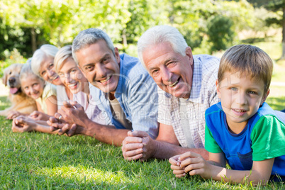 Smiling family looking at the camera with their dog