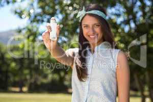 Pretty brunette using her inhaler