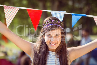 Pretty hipster posing for camera with flags