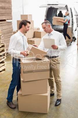 Warehouse managers checking their list