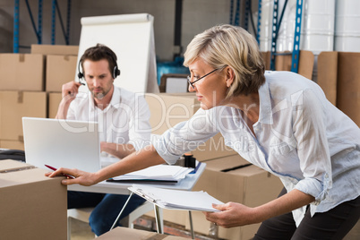 Warehouse manager checking her inventory