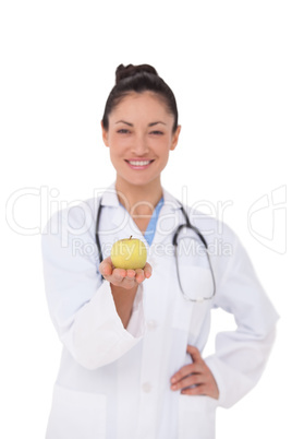 Smiling doctor offering an apple