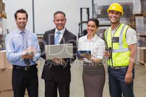 Smiling warehouse team working together