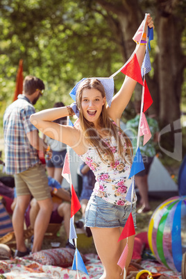 Pretty hipster posing for camera with flags