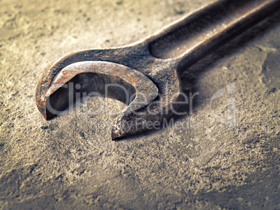 Old rusty wrench close-up in vintage style