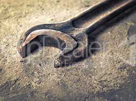 Old rusty wrench close-up in vintage style