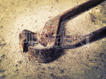 old iron pincers on concrete closeup