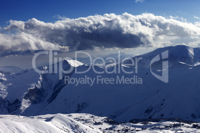 Winter mountains at evening and sunlight clouds