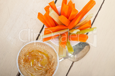 fresh hummus dip with raw carrot and celery