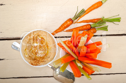 fresh hummus dip with raw carrot and celery