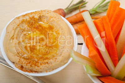 fresh hummus dip with raw carrot and celery