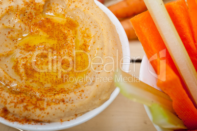 fresh hummus dip with raw carrot and celery