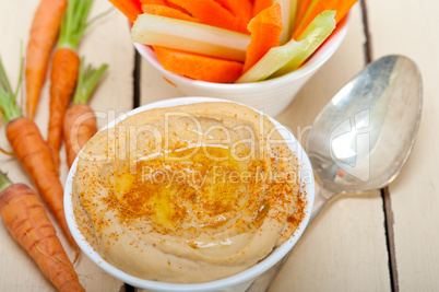 fresh hummus dip with raw carrot and celery