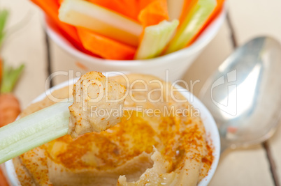 fresh hummus dip with raw carrot and celery