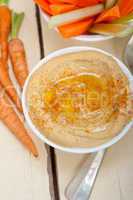fresh hummus dip with raw carrot and celery