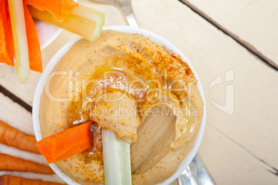 fresh hummus dip with raw carrot and celery