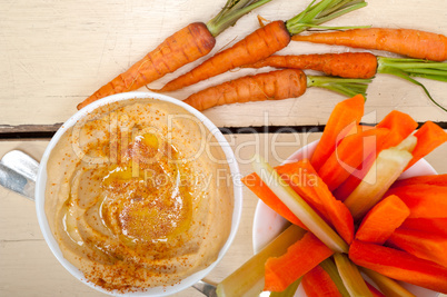 fresh hummus dip with raw carrot and celery