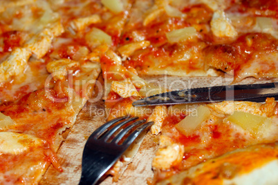appetizing pizza cut by knife and fork