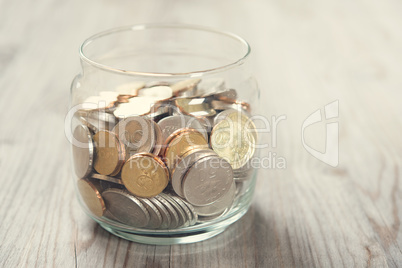 Coins in glass money jar