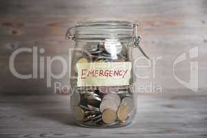 Money jar with emergency label.