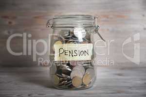 Money jar with pension label.